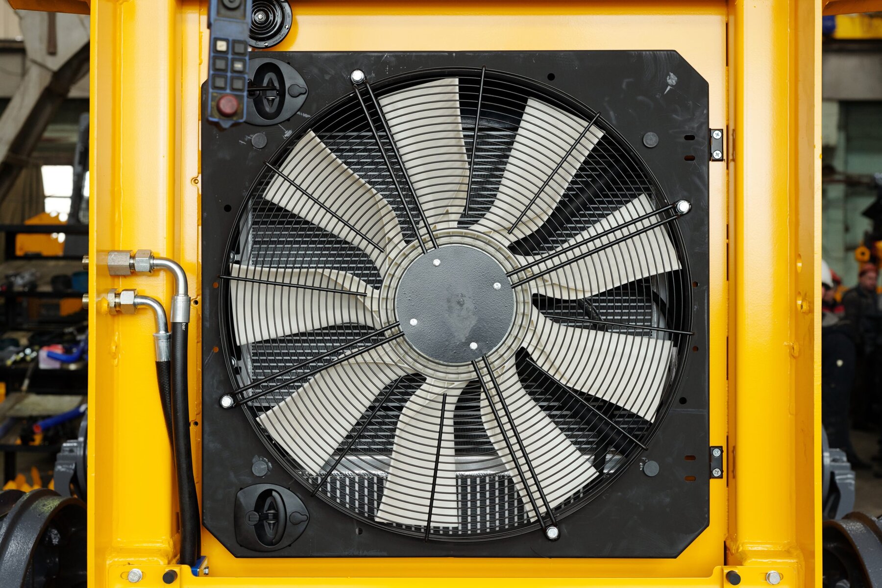 Close-up of part of huge industrial or construction machine with electric fan necessary dor cooling its engine during work