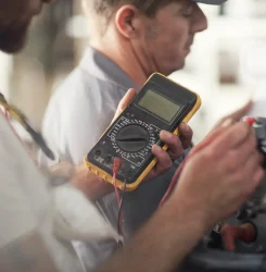 technicians-working-on-machinery-with-a-multimeter-2025-04-04-12-43-56-utc