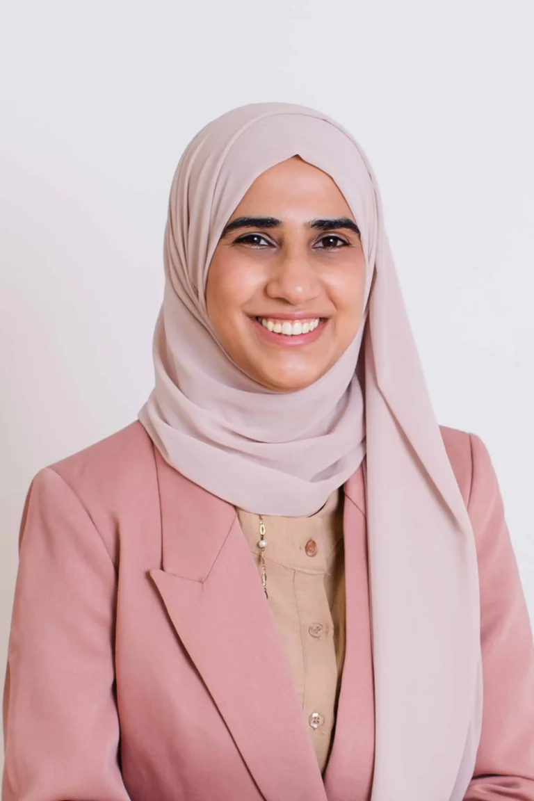 Fatima Bint Saeed headshot in a nude hijab, pink blazer and beige top