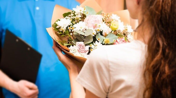 courier-hands-bouquet-young-woman-flower-delivery