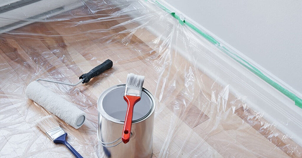 Floor trim with plastic and tape to protect the floor