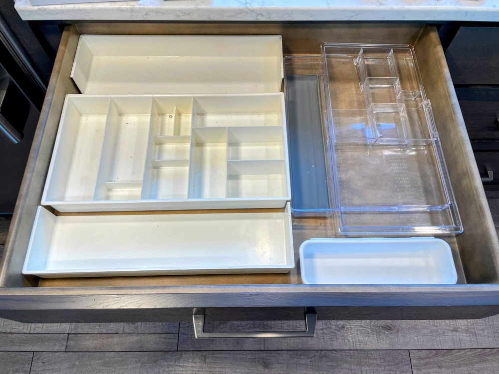 empty drawer with a hodgepodge of plastic organizing trays