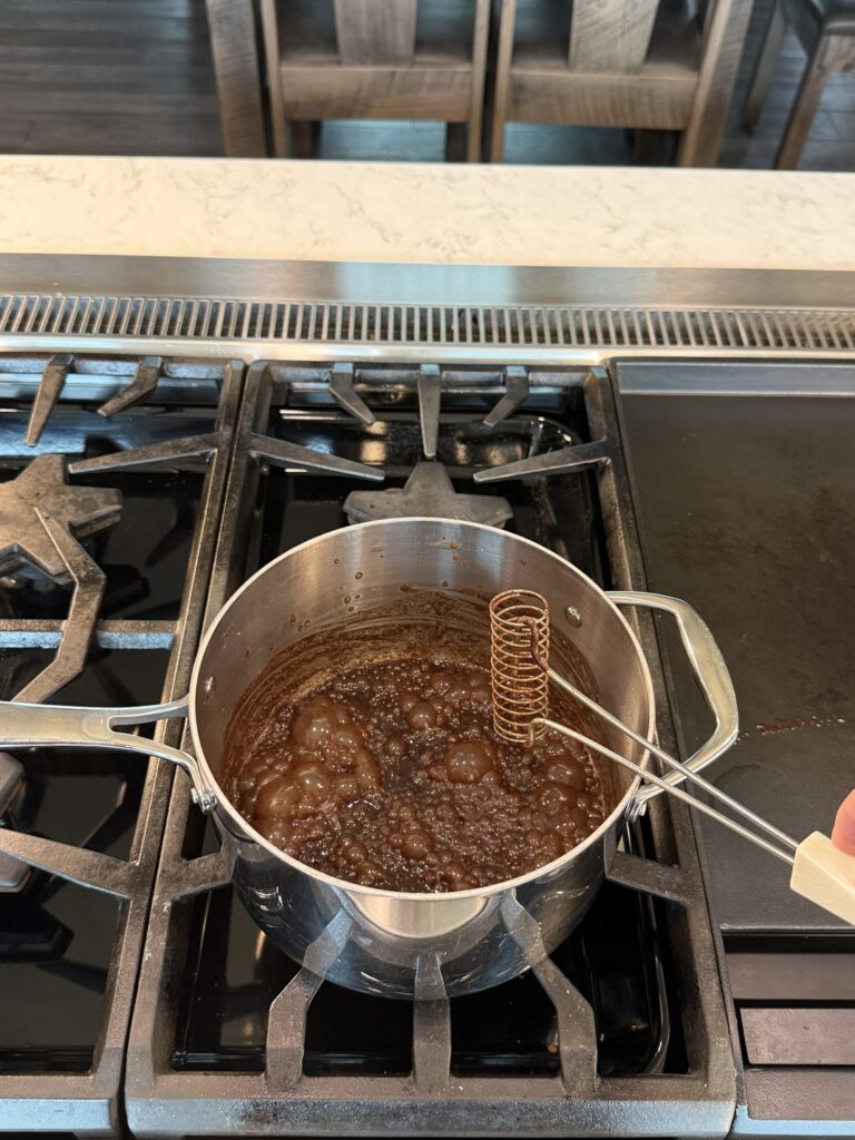 whisking the icing at a gentle boil