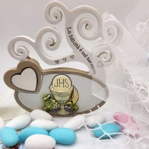 A wedding cake with a heart shaped box and candy.