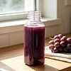 A 12oz PET square juice bottle contains grape juice
