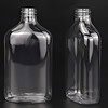 Clear plastic bottles with screw caps for packaging or storage.