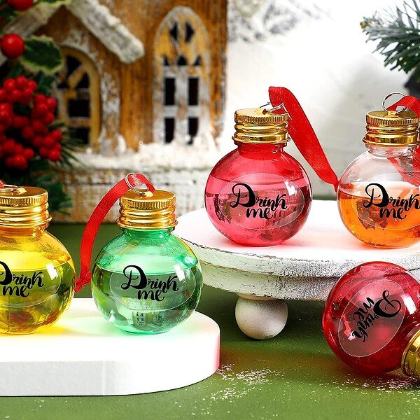 Brightly colored 2oz round plastic bottles with "Drink me" label and red ribbons, perfect for holida.