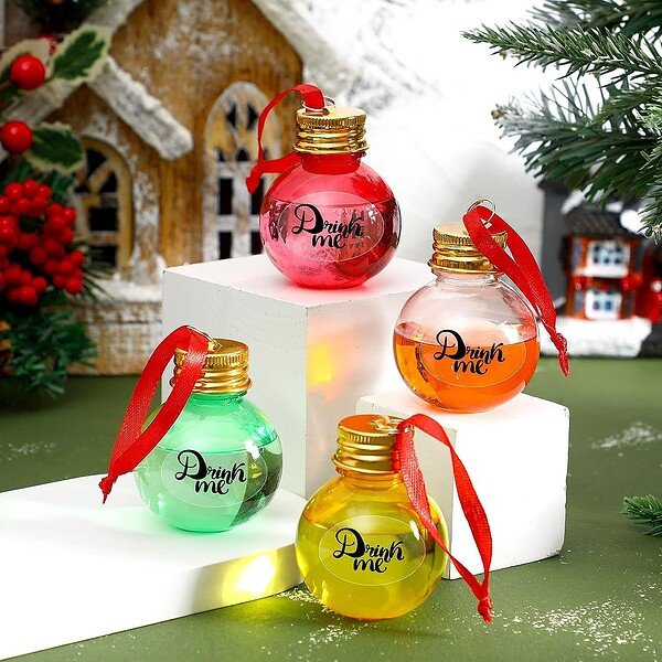 Pink, orange, green, and yellow 2oz round plastic bottles with gold caps and "Drink me" label, decor.