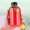 A 16oz (500ml) round PET juice bottle filled with juice is held in my hand.
