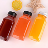Three 8oz (250ml) square, clear, empty PET plastic juice bottles are placed on the table.