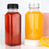 Clear plastic bottles with black and silver caps for beverages or supplements.