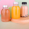 Bulk purchase of 250ml (8oz) round, clear, empty juice bottles, equipped with tamper-evident caps.