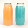 Colorful plastic bottles with silver lids on white background.