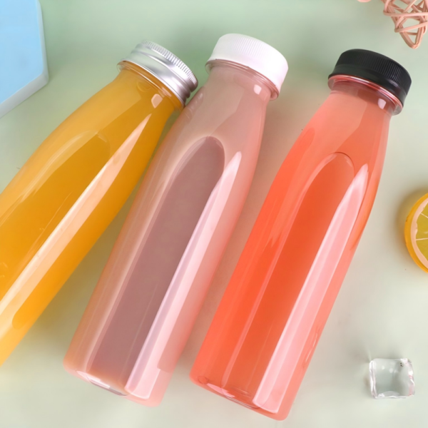 Colorful plastic bottles for beverages on a pastel background.
