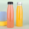 Clear plastic bottles with black and silver caps for beverages or liquids.