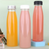 Set of three colorful plastic bottles with different caps on pastel background.