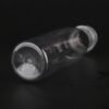 Clear plastic PET bottle for beverages with a white cap on black background.