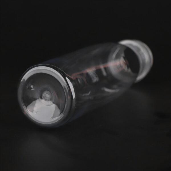 Clear plastic PET bottle for beverages with a white cap on black background.