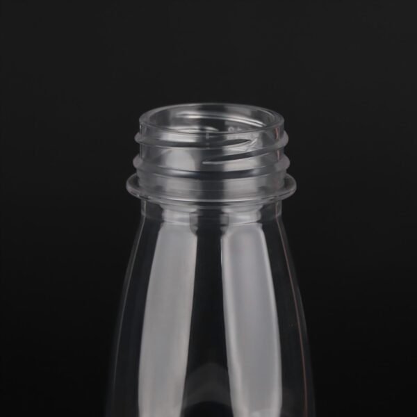 Clear plastic bottle for beverages with screw cap opening.