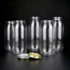 Clear glass jars with metal lids on black background.