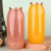 Colorful glass and plastic bottles with metal lids on a pastel background.