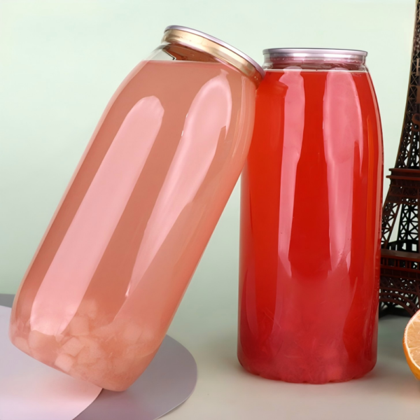 Clear and red plastic bottles with metal lids on a white surface.