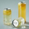 Clear PET soda cans with lemon slices and ice, easy open lid design.