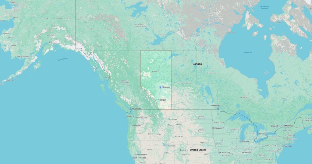 Scenic view of a mountain range with a lake in the foreground, showcasing lush greenery and clear blue waters in the Pacific Northwest region.