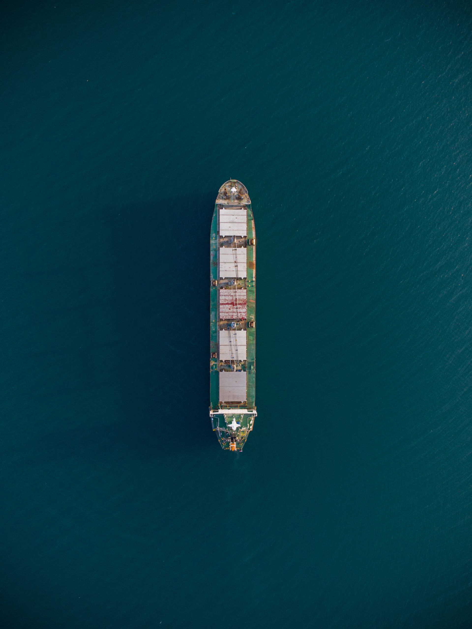 Bird’s-eye view of a container ship sailing in open ocean