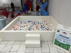Party ball pit with colorful plastic balls for children's entertainment at events.