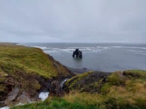 Unique sea stack along the Westfjords coast in Iceland.