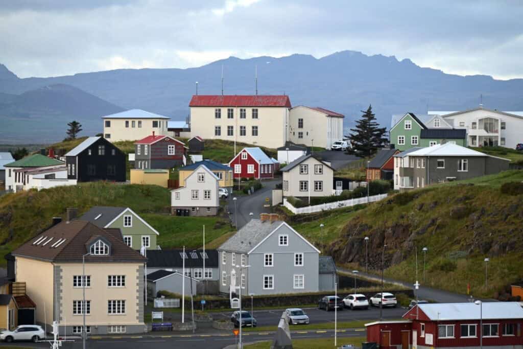 Vibrant Icelandic village with colorful houses and mountain views near Snæfellsnes Peninsula.