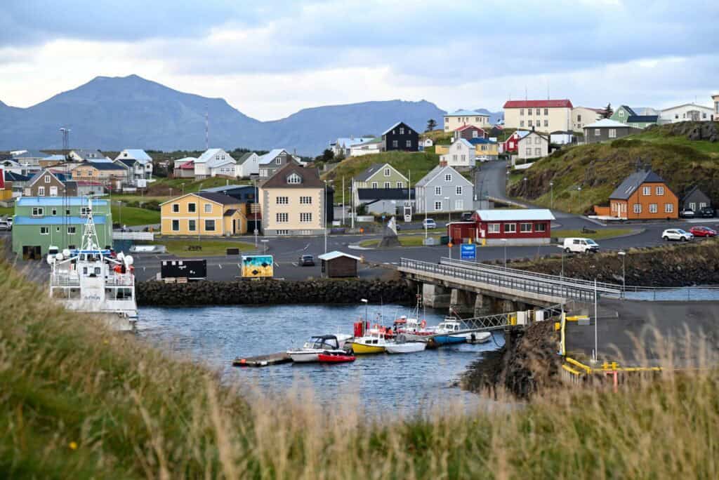Colorful houses and boats in a coastal village on the Snæfellsnes Peninsula, Iceland.