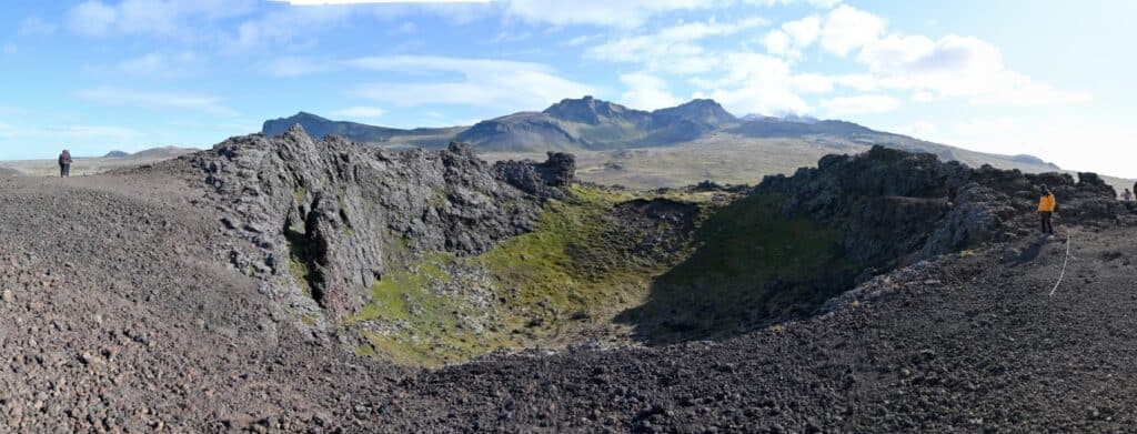 Volcanic crater on the Snæfellsnes Peninsula with rugged terrain and scenic mountain views.
