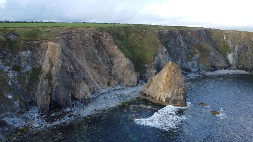 Dramatic cliffs along Ireland's Copper Coast with rugged coastline and ocean waves.