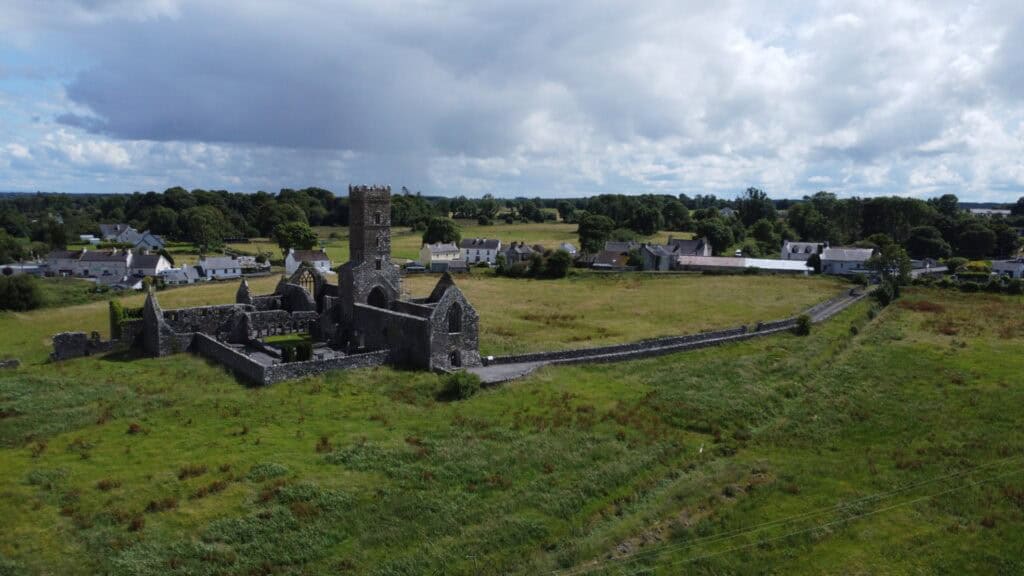 Scenic Irish countryside with historic castle near Dingle to Dublin route.