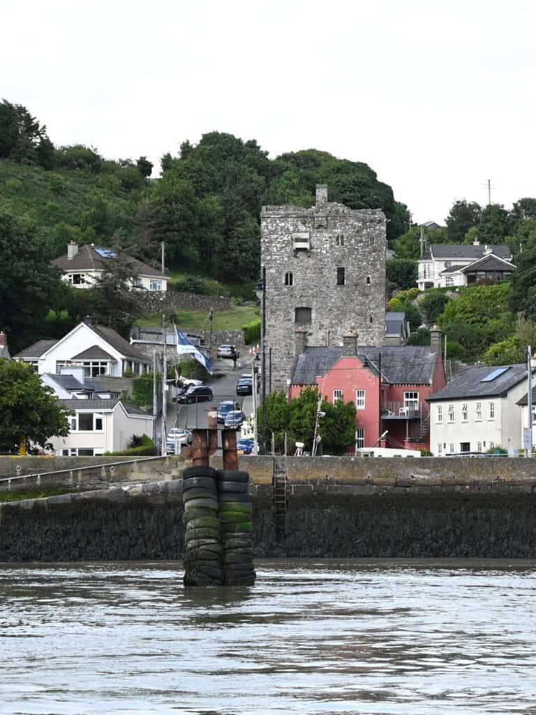 Ancient castle overlooking a charming Irish village on the Copper Coast, Cork, Ireland.