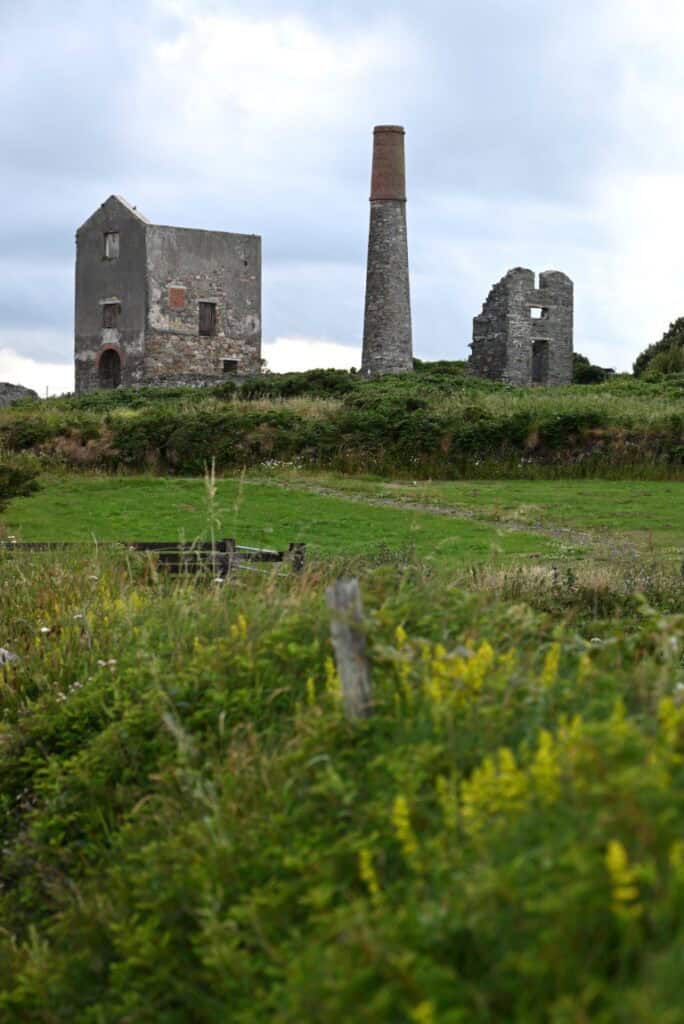 Ancient ruins and chimney on the Irish Copper Coast, Cork, showcasing historic industrial sites.