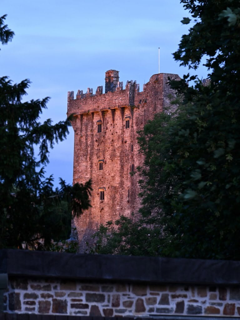 Historic Irish castle surrounded by lush greenery in Cork, Ireland.