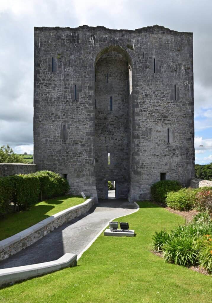Ancient stone castle tower along the Dingle to Dublin route, showcasing Irish heritage and scenic la.