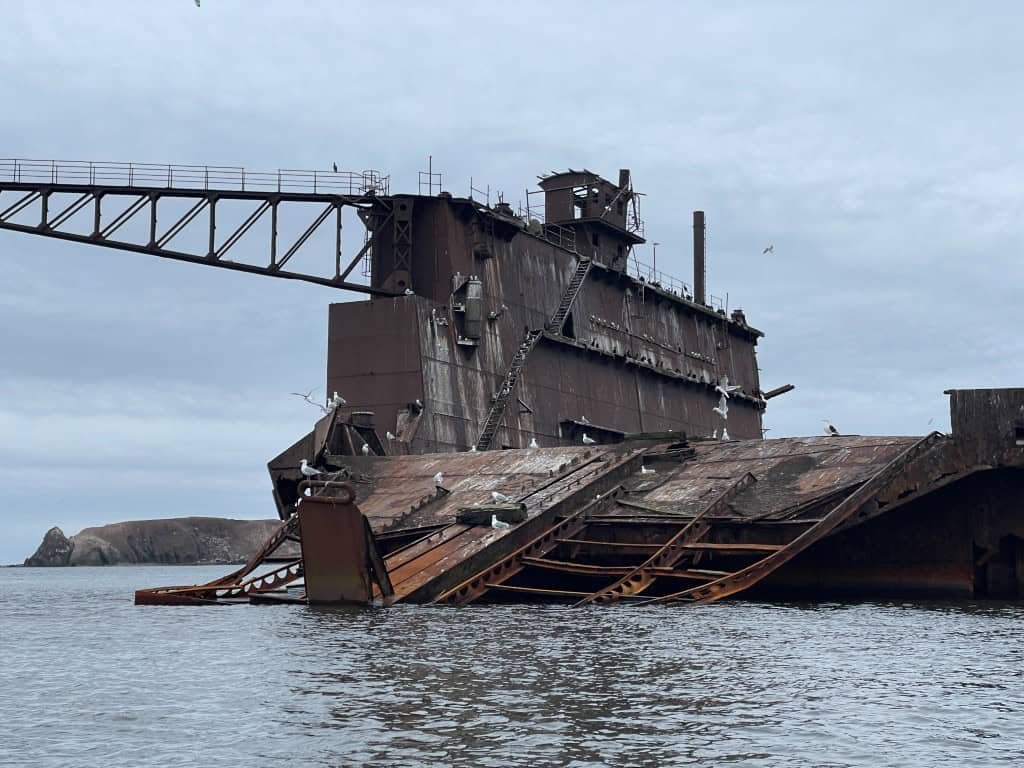 Rusty shipwreck on the coast of Îles-de-la-Madeleine in May.
