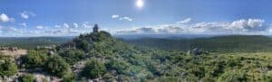 Scenic view of Mount Carleton, highest point in the Maritime Provinces, with lush greenery and blue.