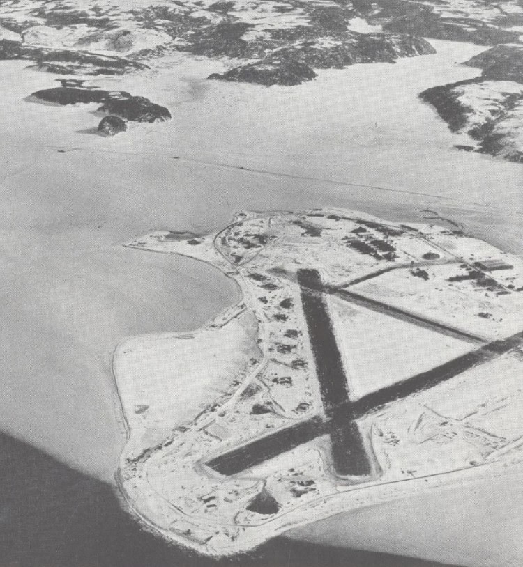 Aerial view of Argentia airfield with runway and surrounding landscape.