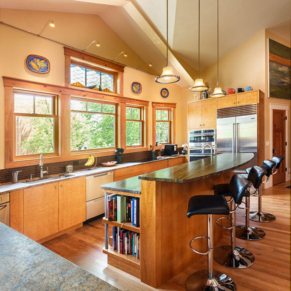 Bright Craftsman-style kitchen featuring large windows and wooden accents.