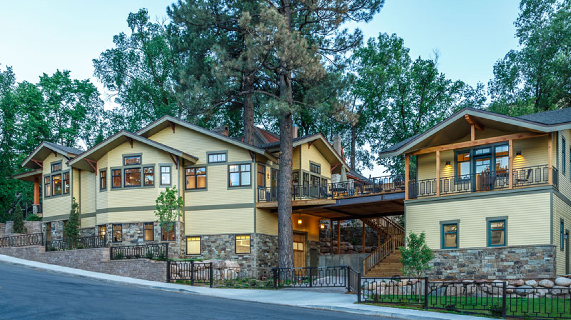 Elegant Craftsman-style home with spacious balconies and large windows.