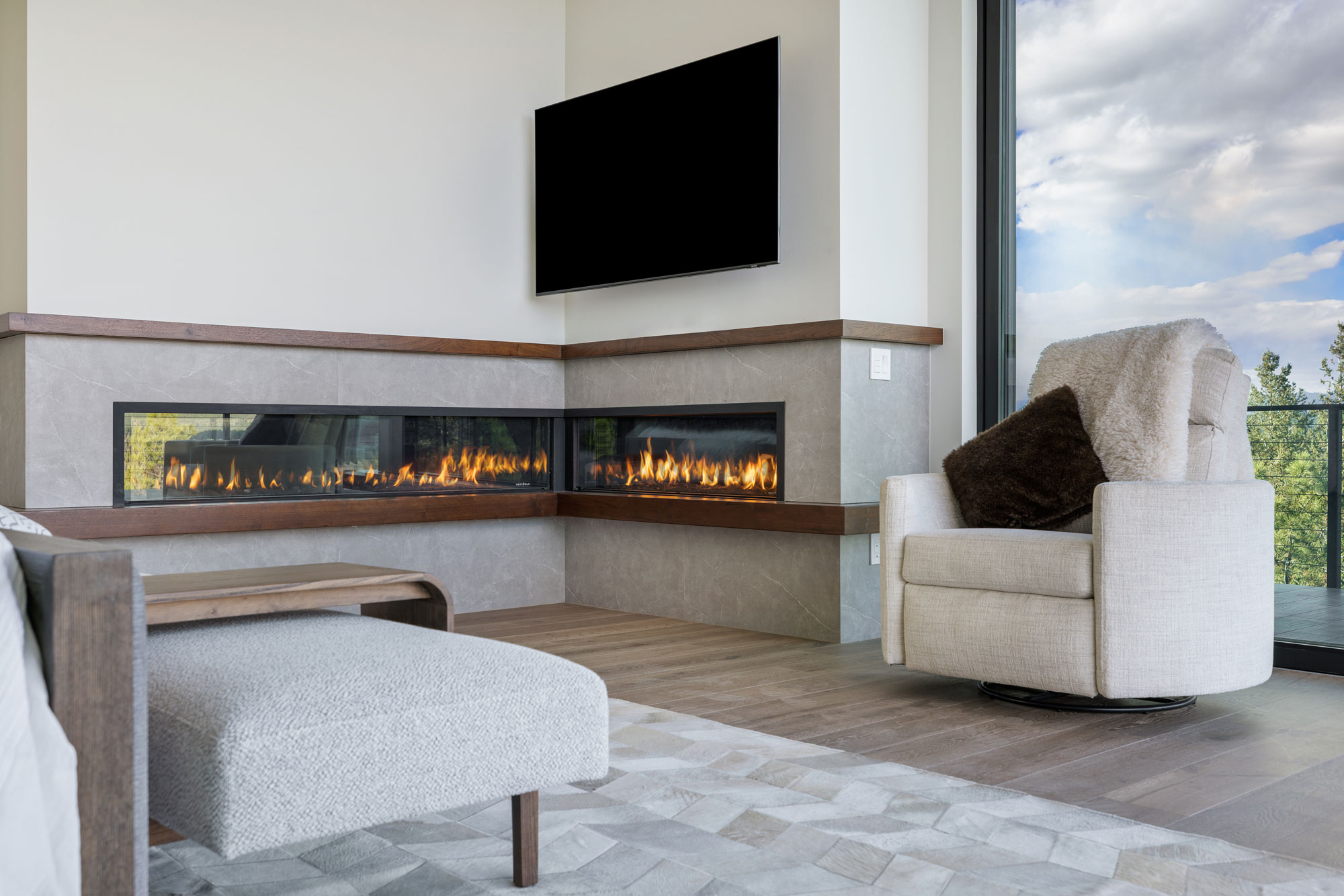 Modern living room with fireplace and large window for natural light.