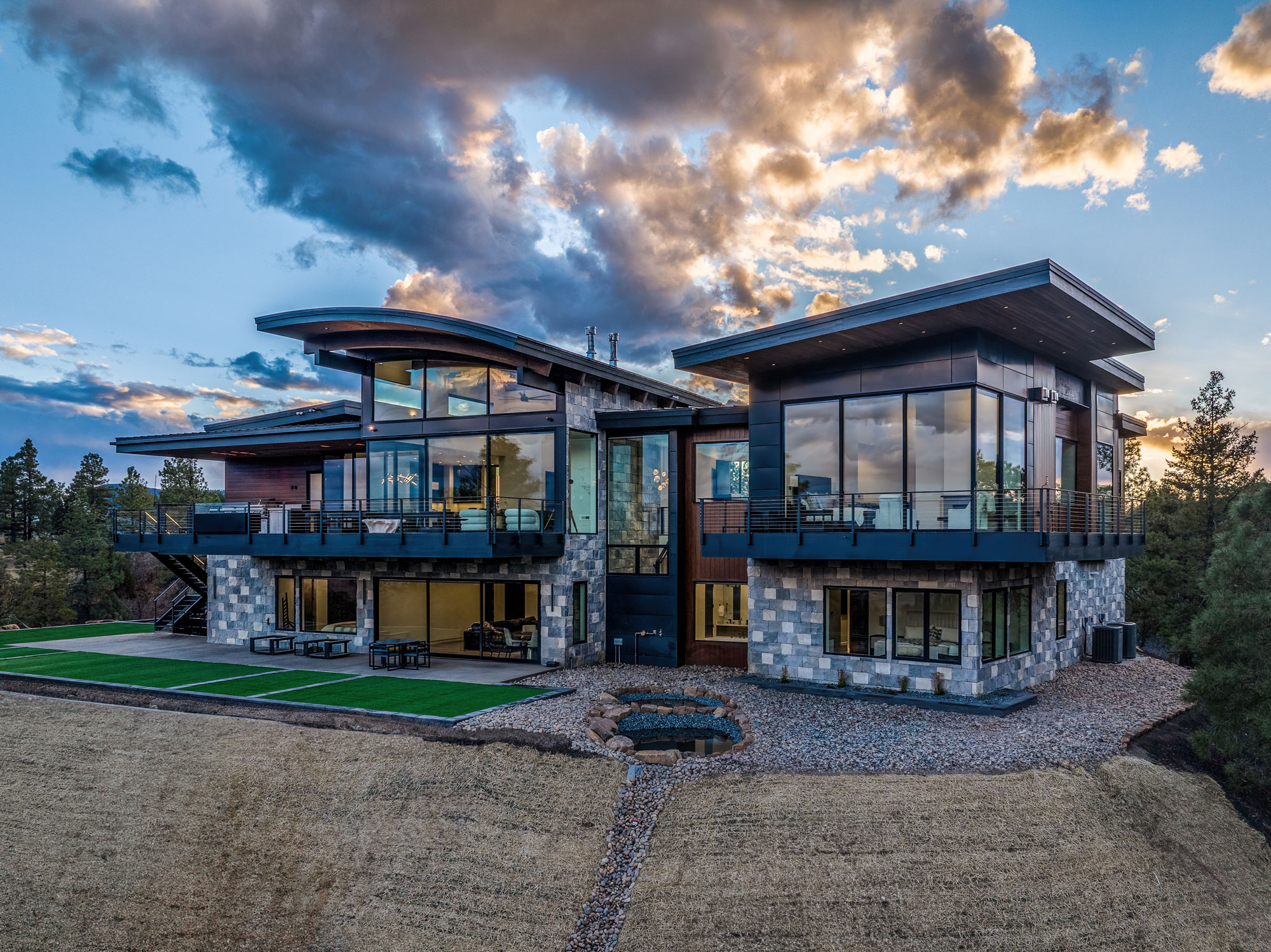 Modern luxury home with large glass windows and sleek architecture.