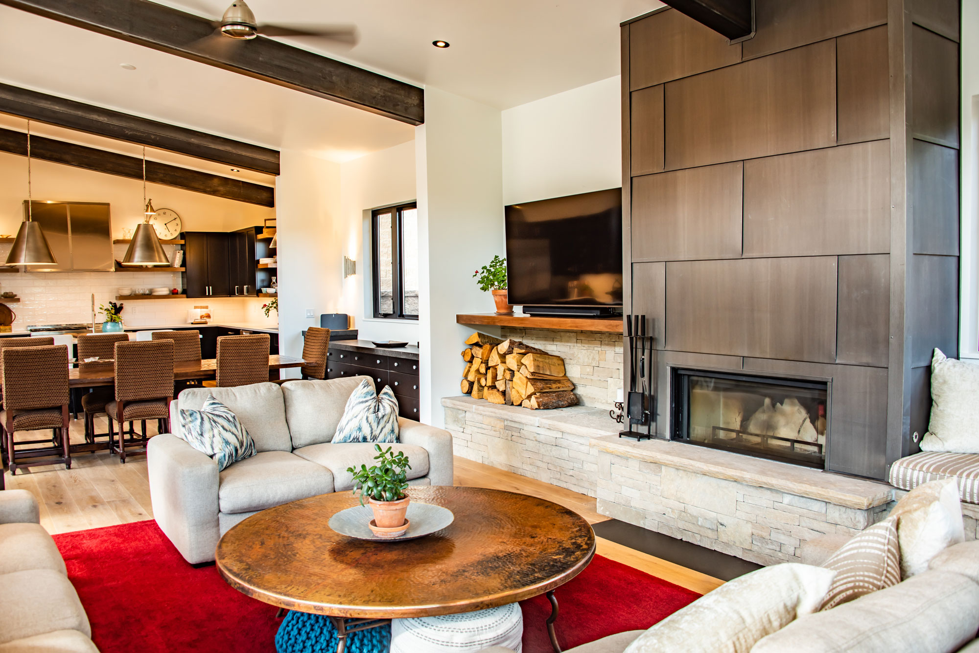Contemporary living room with fireplace, cozy seating, and modern decor.