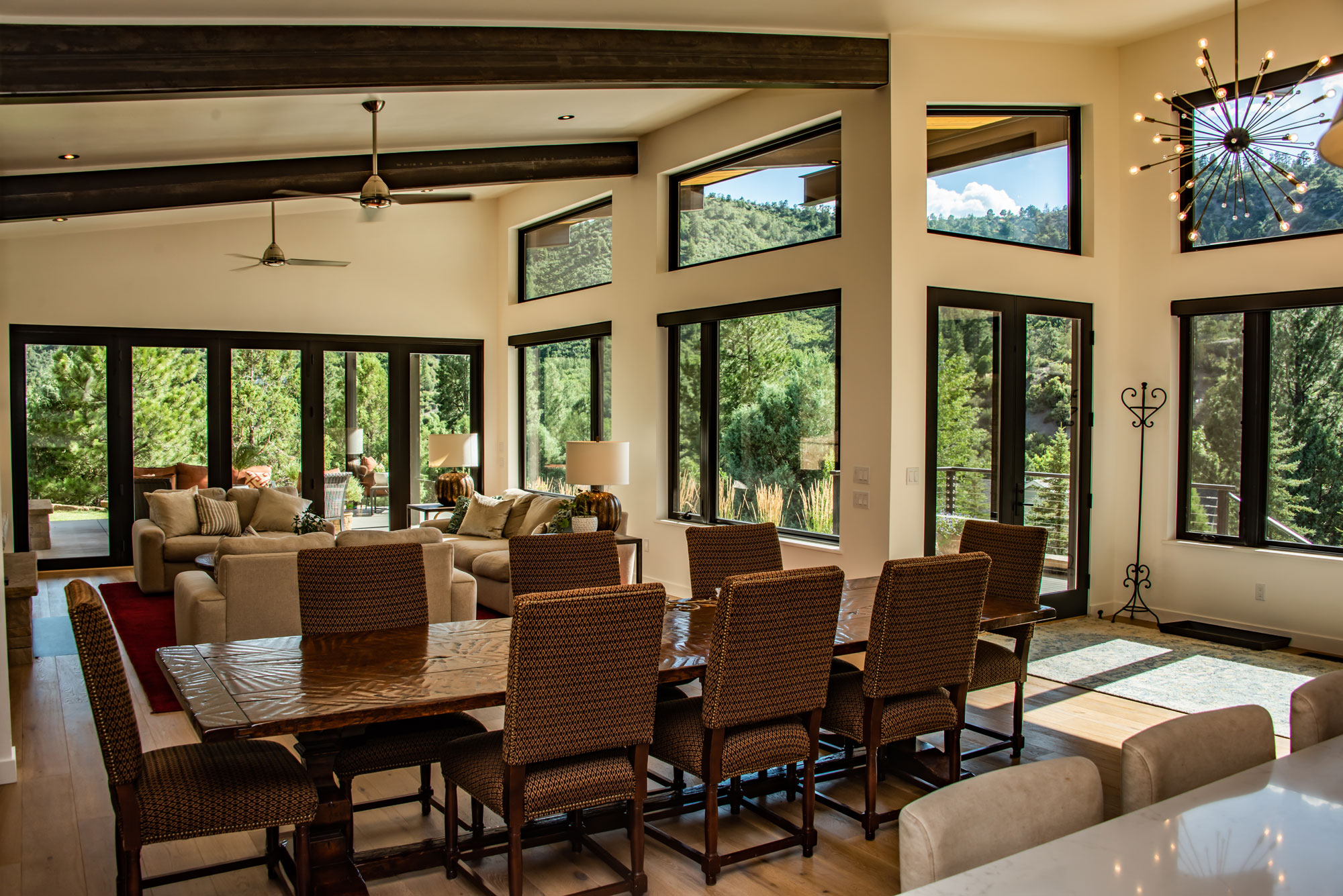 Spacious modern living room with large windows and natural light.