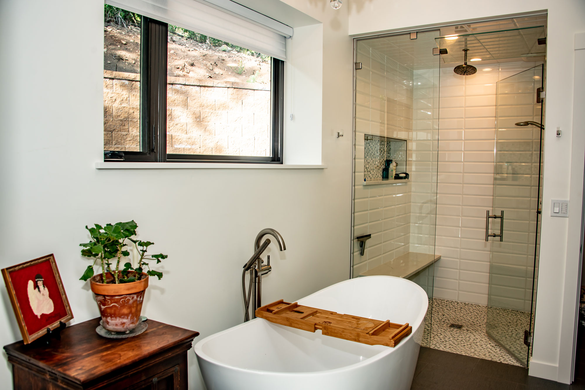 Contemporary bathroom with freestanding tub and glass shower enclosure.